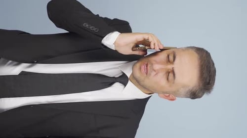 Man in Suit Talking on Mobile Phone