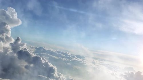 cumulus clouds moving in the clear blue sky
