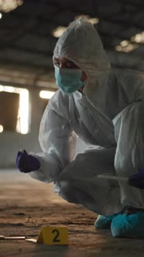 Scientist Collecting Evidence at Crime Scene