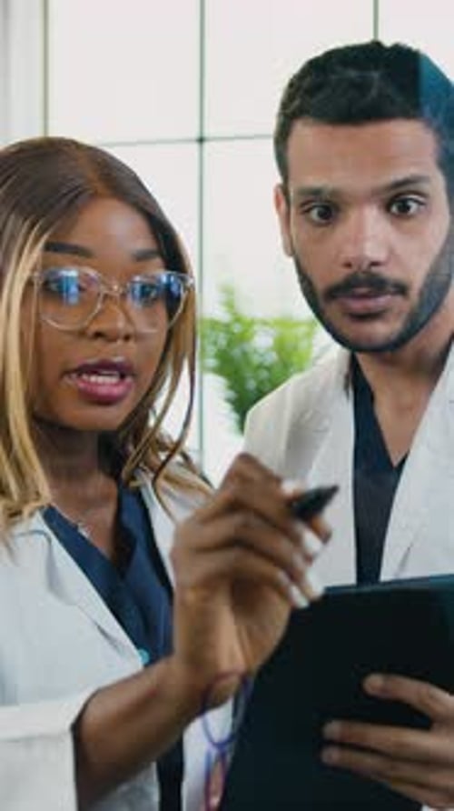 Beautiful Confident 35Aged African American Female Medical Scientist Talking with Her Male Colleague