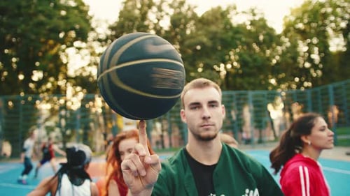 Man Spinning Basketball on Finger at Outdoor Court