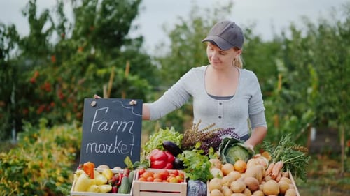 Portrait of a Seller at a Vegetable Market with a Farm Market Sign