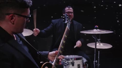 Guitarist and Drummer Perform Live Music on Stage