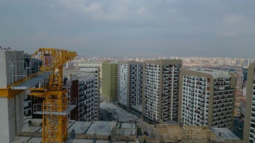 Tower crane working on a multi-story construction site