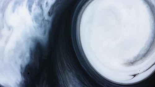 Abstract white paint swirl slowly pushing back black cloudy shape ink liquid