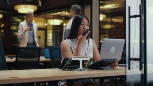 Woman Having Phone Conversation in Office