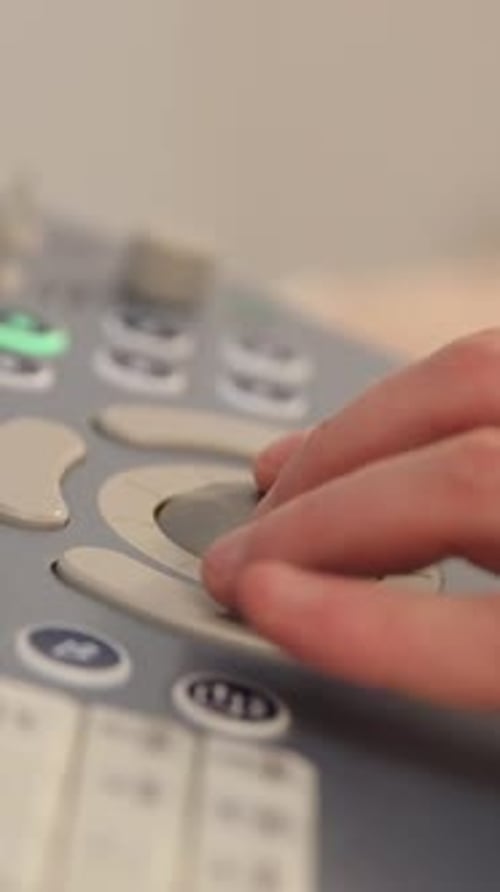 Hand Operates Medical Machine Controls in Hospital
