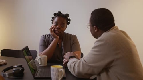 Woman and Man Discussing Something at a Table