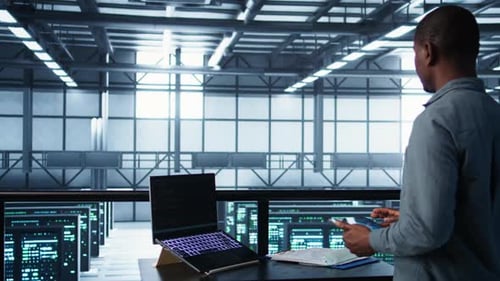 Technician in Data Center with Laptop and Tablet Integrating AI Technology