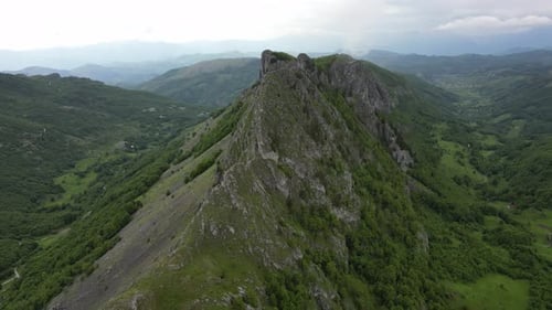Flying over beautiful green mountains. Aerial view.