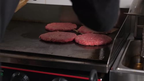 Hamburger Patties Cooking on Commercial Grill