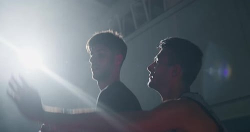 Cinematic slow motion close up shot of young professional male players are practicing a basketball