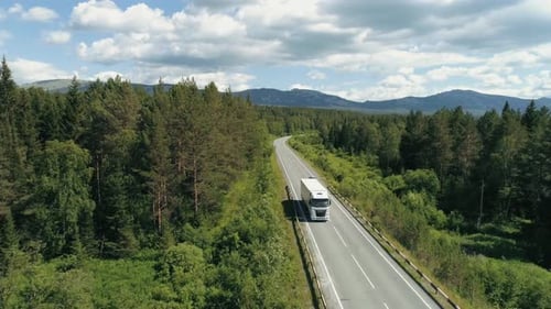 Top View of Truck Driving Along Highway in Forest Area