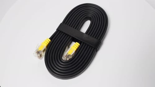 Black Ethernet Cable Coiled on White Background