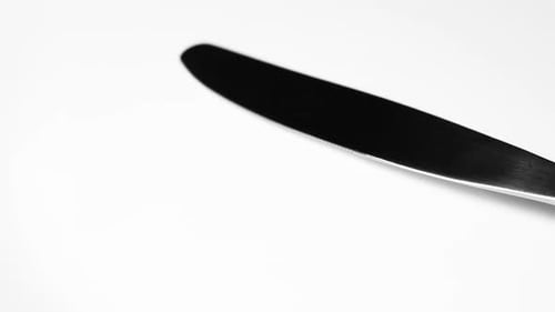 Knife and Fork on white surface close up video