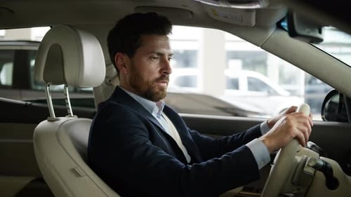 Man in Car Adjusts Vehicle's Settings