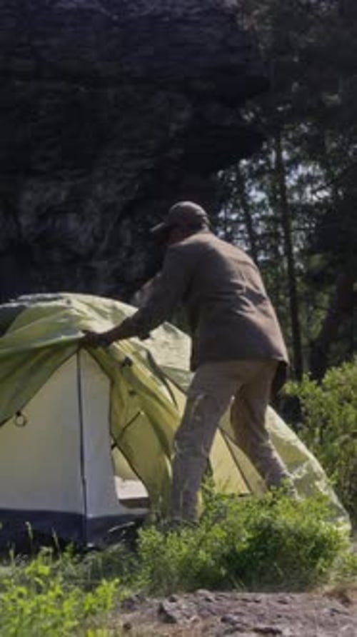 People Assemble Tent in Mountain Wilderness