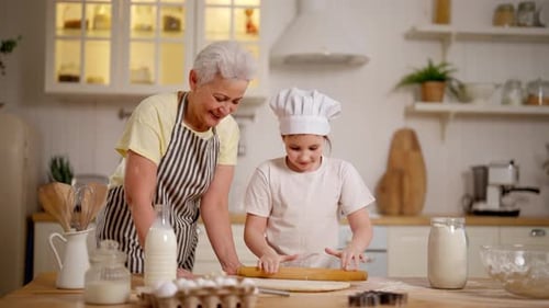 Child and Senior Woman Baking Together in Kitchen