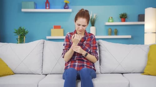 Woman Massaging Wrist in Painful Discomfort
