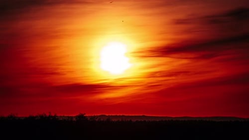 Timelapse of Dramatic Sunset in the Orange Sky Through Clouds