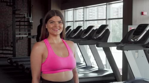 Woman Lifting Dumbbell at the Gym