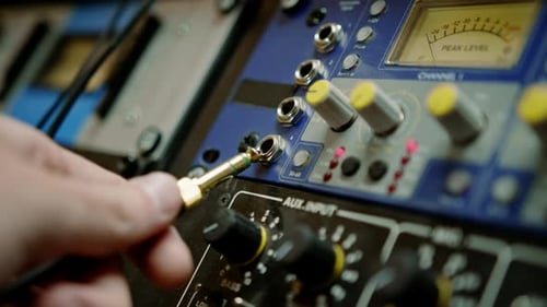 sound engineer connects Audio cable Professional wires with connectors to music equipment recording