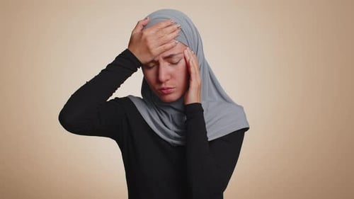 Woman Massaging Temples due to Headache Pain