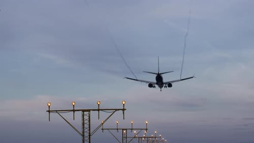 Commercial Airplane Flies Overhead Approaching Airport