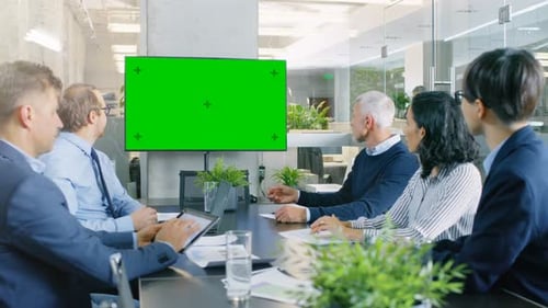 Diverse Group of Successful Business People in the Conference Room with Green Screen Chroma Key TV