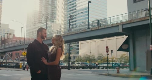 A Creative Romantic Shot of a Loving Couple in a Big City at Sunset A Woman and a Man Dressed in the