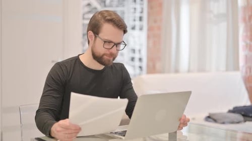 Man Working on Laptop at Home Office Desk