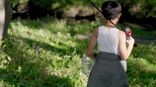 Boy Walking with Fishing Pole and Fishing Net in Sunny Park 89 Years