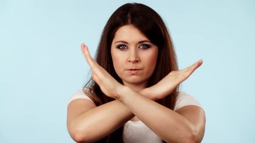 Woman Gesturing No or Rejection With Arms Crossed