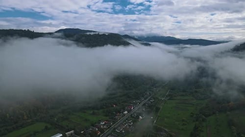 Amazing Aerial View of Houses in Mountain Village Cloud Around Forest on Mountain Hills Slow Motion