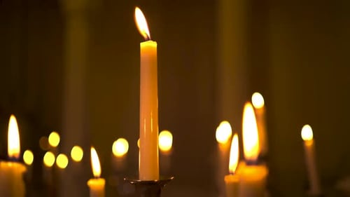 Burning Candles Glowing Softly in the Dark