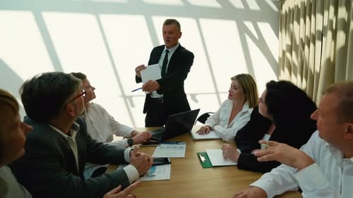 Business Professionals in Meeting Presenting Data and Strategy