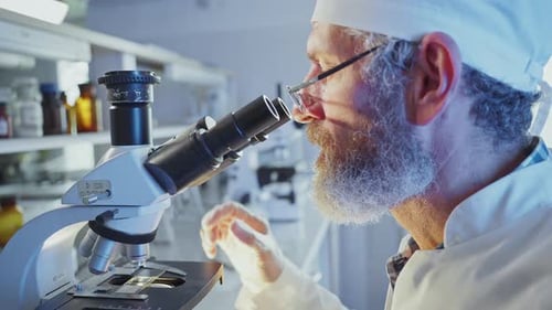 Scientist Using Microscope in Research Laboratory