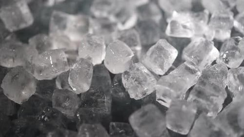 Shiny Ice Cubes Being Scooped Up Close