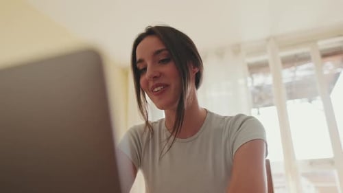 Woman Video Chatting on Laptop at Home