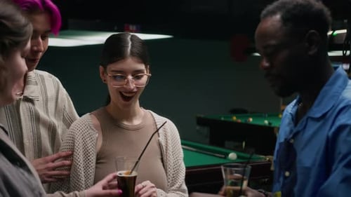 Multiethnic Friends Having Double Date at Pub with Pool Table