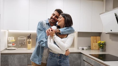 Affectionate Couple Embrace in Modern Kitchen