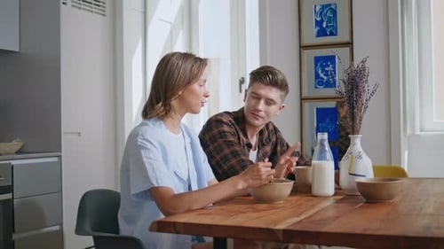 Couple Enjoying Breakfast Together in Sunny Kitchen