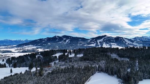 Snow covers the spectacular mountains, pine tree woods and meadows.