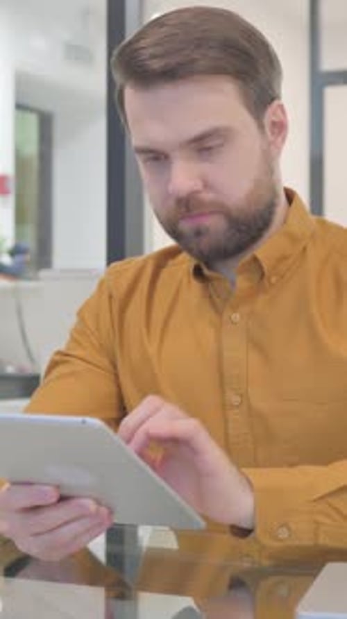 Casual Creative Man Using Digital Tablet, Vertical Video