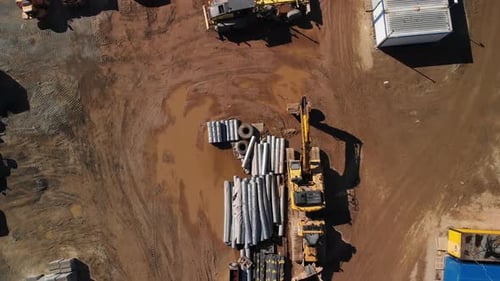Aerial top down view of a backyard storage of materials and on the freeway construction site