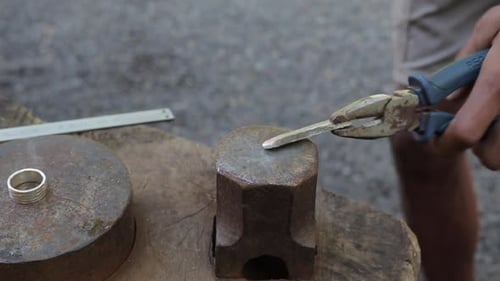 Forge silver shaping process with hammer by jeweler