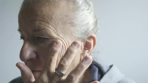 Senior Woman Applying Moisturizer to Her Face
