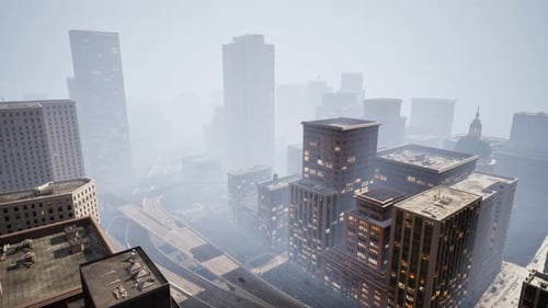 Cinematic Aerial View of Modern City Buildings in Hazy Fog