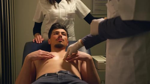 Young Adult Examined by Medical Professionals in Clinic