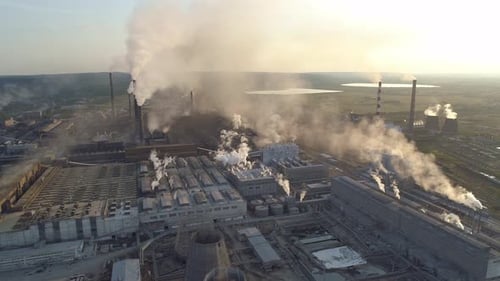 Aerial Panoramic View of an Industrial Zone with a Large Factory Many Pipes Pouring White Smoke